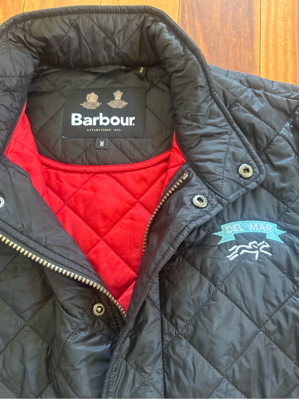 Barbour womens Quilted Jacket in Black with Red Lining Del Mar logo